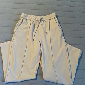 Cream pull-on Antonio Melani pants w/ elastic waist & drawstring. Pintuck seams.